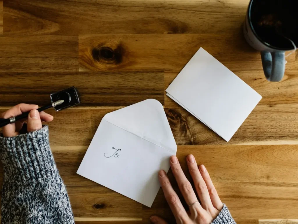Documents and envelopes on a desk for a KITAS address change